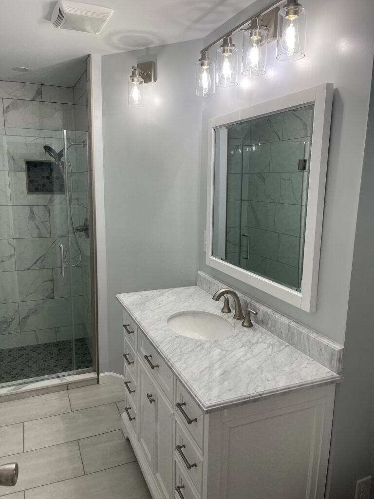 In this particular project, we focused on installing new wall tiles and a vanity, as well as incorporating groutless showers for a sleek and modern look.